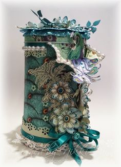 an ornate vase with flowers and ribbons on it