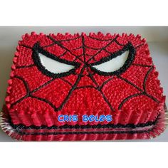 a spiderman cake with the words cris bolos on it's side