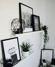 there are some pictures and plants on the wall