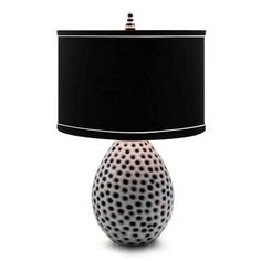 a black and white table lamp with a black shade on the top, sitting against a white background