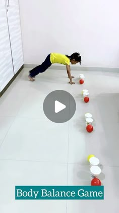 a person is playing with some balls on the floor