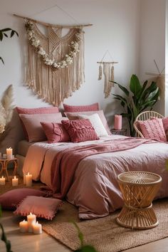 a bedroom with pink bedding and candles on the floor