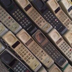 many different types of cell phones lined up in the same row and one is missing