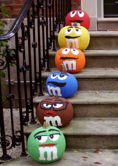 colorful balls with faces are lined up on the steps