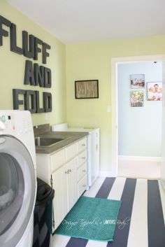 a washer and dryer sitting in a room next to each other on a striped rug