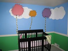 a baby's room with three dr seusst trees painted on the wall