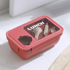 a lunch box with shoes in it sitting on a counter