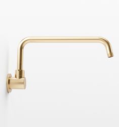 a gold faucet mounted to the side of a white wall