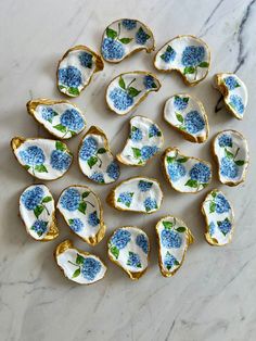 blue and white porcelain flowers are arranged on a marble surface