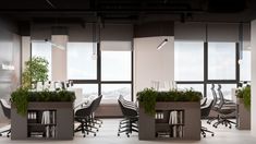 an office with plants growing in the middle of two desks and chairs around them