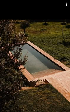 an empty swimming pool in the middle of a field