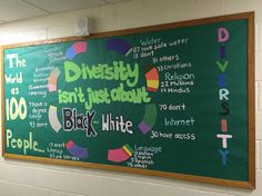 a blackboard with words written on it in a school hallway, next to a bulletin board