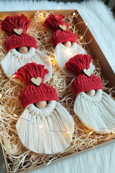 decorated cookies in the shape of santa's faces are on top of some straw