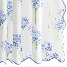 a shower curtain with blue flowers on it