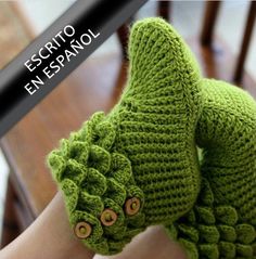 a woman's legs wearing green knitted mittens