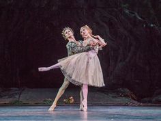 two ballerinas in tutu and tiara, one is holding the other