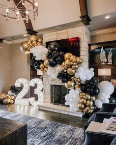 the balloon arch is decorated with black, gold and white balloons that read twenty two