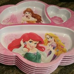 there are many princess plates on the counter