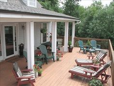 a wooden deck with chairs and potted plants on it