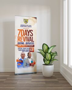 a poster stands next to a potted plant in front of a white wall that says 7 days revival fasting and apprexiis