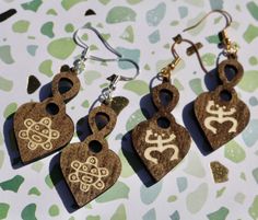 1 1/2in X 1in Heart Taino Symbol Laser-Cut & Burn, Bass Wood Dangle Earrings. Hang down from ears at approximately 2 1/2 inches.  Come in 2 Styles to choose From: 1. Taino Sol Heart Hypoallergenic Silver-Plated Copper Earring Hooks (approx. 20mm in height). Metal Jump Rings & Clear Silicone Rubber EarringBacks. 2. Taino Coqui Heart Hypoallergenic Sliver-Plated (Gold Colored) Copper Earring Hooks. (approx. 20mm in height) Metal Jump Rings & Clear Silicone Rubber Earring Backs. Inspired by the Tai Taino Ring, Taino Patterns, Ancient Taino Jewelry, Puerto Rican Earrings, Taino Symbols, Hawaiian Earrings Wood, Wood Dangle Earrings, Laser Cut Wood, Copper Earrings