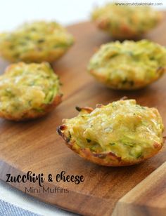 mini muffins with zucchini and cheese in them on a cutting board