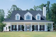 a large white house with black shutters on the front