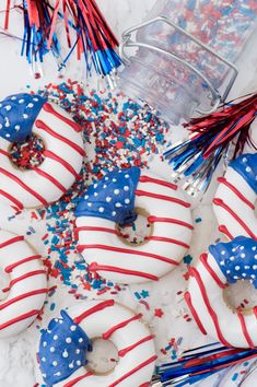 patriotic donuts with red, white and blue sprinkles are on the table