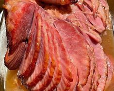 sliced meat sitting on top of a metal pan