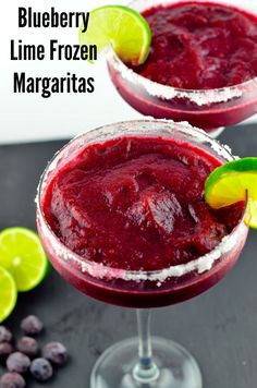 two glasses filled with blueberry lime frozen margaritas