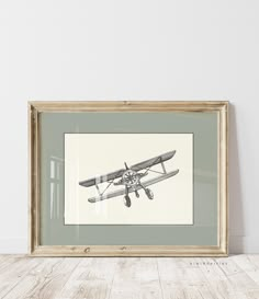 an old airplane is hanging on the wall above a wooden table with a white background