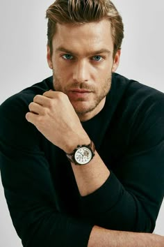 a man wearing a black shirt and watch