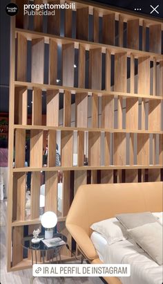 a bed sitting in front of a wooden book shelf