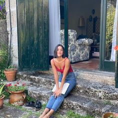 a woman sitting on steps in front of a house