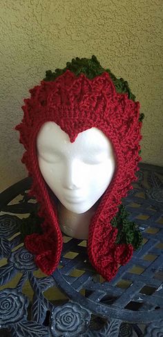 a white mannequin head wearing a red knitted hat