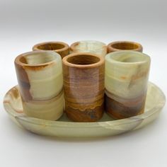 a group of vases sitting on top of a plate