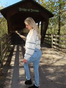 a woman standing on the side of a bridge