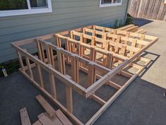 a house being built with wooden framing on the ground