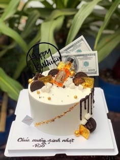 a birthday cake decorated with money and coins