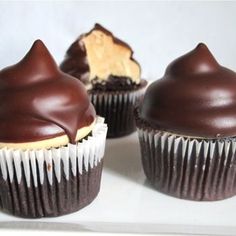 three chocolate cupcakes on a white plate