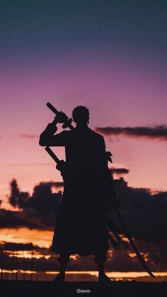 the silhouette of a man holding a baseball bat in front of a purple and blue sky