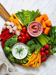 a platter filled with veggies and dips