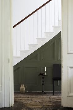 an open door leading to a room with green walls