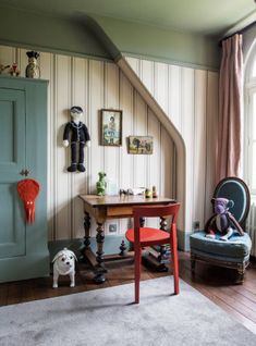 a room with a chair, table and stuffed animal on the floor next to it