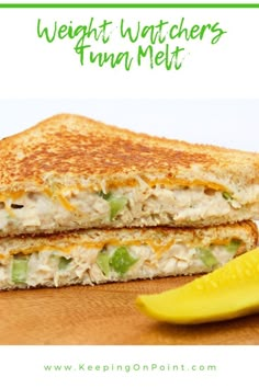 a close up of a grilled cheese sandwich on a cutting board with a banana