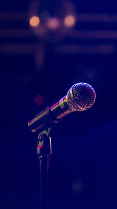 a microphone is shown in front of a dark background