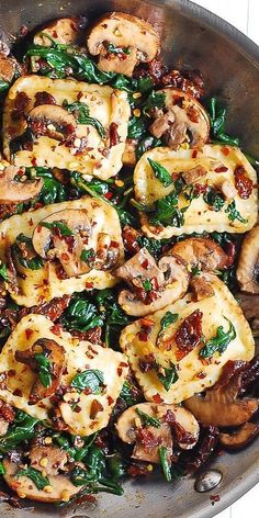 a pan filled with chicken and spinach covered in sauce