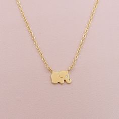 Check out our adorable tiny elephant necklace! It features a cute elephant charm attached to a delicate cable chain, complete with a tiny crystal eye for a hint of sparkle. Elephants are a symbol of good luck, so wear this necklace as your very own good luck charm! DETAILS: 16 inches long with a 2 inch extender Can be worn 16-18 inches sterling silver or 14kt gold plated over sterling silver CZ accent stone Wear it layered with our Satellite Choker Necklace as seen on the model. Elephant Design Gold Jewellery, Elephant Design Necklace Gold, Personalized Gold Jewelry, Elephant Charm Necklace, Tiny Elephant, Pearl Necklace Earrings, Crystal Eye, Elephant Necklace, Luck Charm