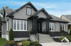 a gray house with white windows and stairs