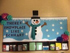 a bulletin board with a snowman on it in the middle of a library area